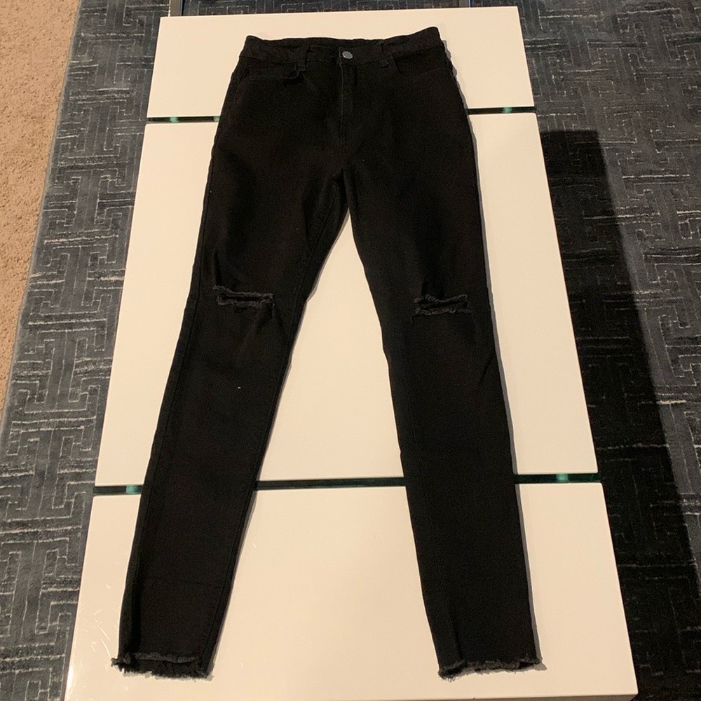These are black SHEIN skinny jeans with holes in the knee.